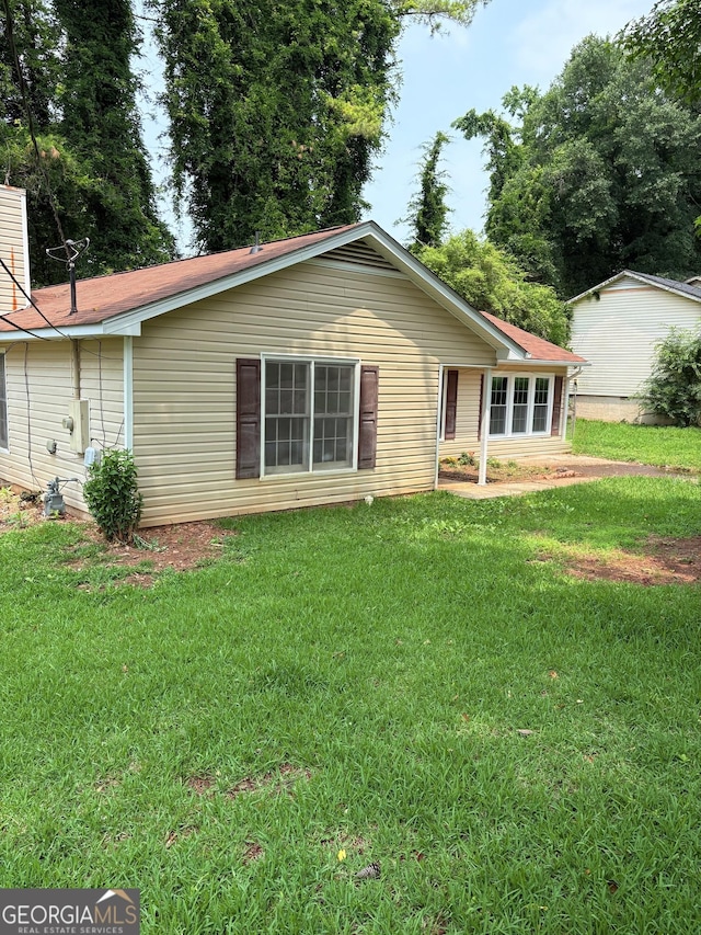 6103 Chaseland Rd, Rex, GA 30273 - rear view of property with a lawn and a chimney