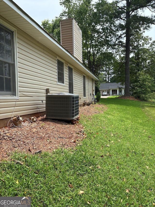 6103 Chaseland Rd, Rex, GA 30273 - view of grassy yard featuring central AC unit