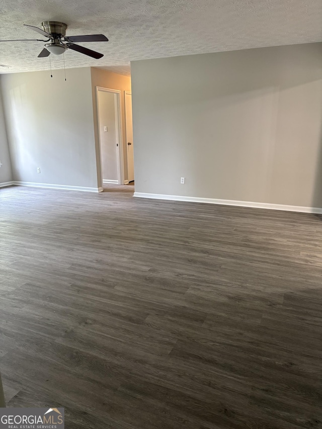 6103 Chaseland Rd, Rex, GA 30273 - spare room with a ceiling fan, baseboards, dark wood-style flooring, and a textured ceiling