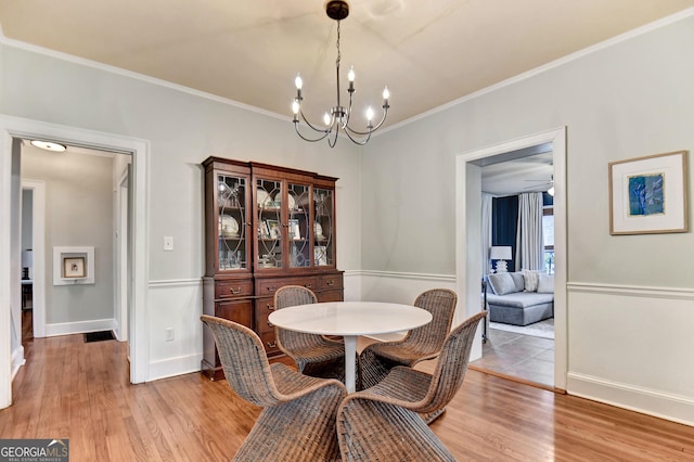 570 Southview Dr, Athens, GA 30605 - dining area featuring a chandelier, wood finished floors, crown molding, and baseboards
