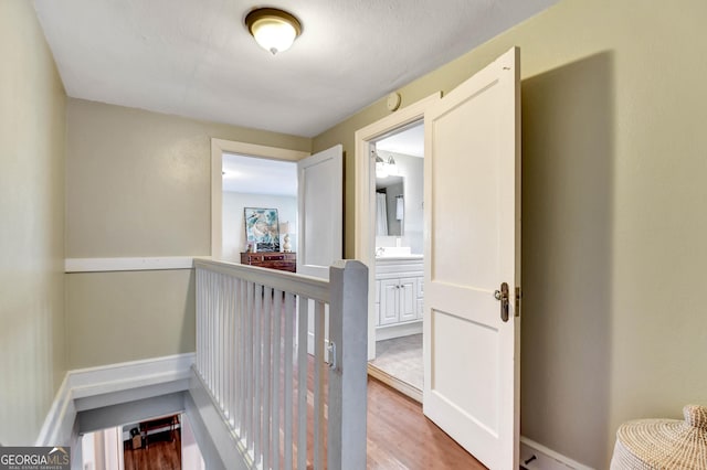 570 Southview Dr, Athens, GA 30605 - hall with wood finished floors, a sink, and an upstairs landing