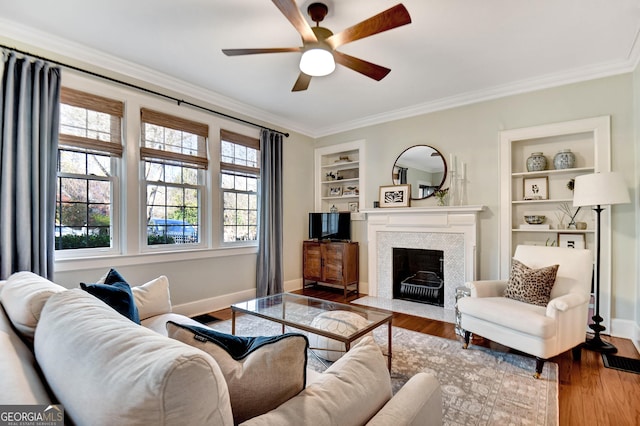 570 Southview Dr, Athens, GA 30605 - living area with built in shelves, ceiling fan, crown molding, wood finished floors, and baseboards