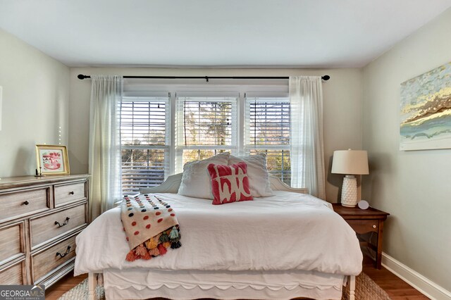 570 Southview Dr, Athens, GA 30605 - bedroom with multiple windows, dark wood-style flooring, and baseboards