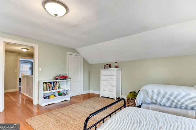 570 Southview Dr, Athens, GA 30605 - bedroom featuring wood finished floors, baseboards, and lofted ceiling