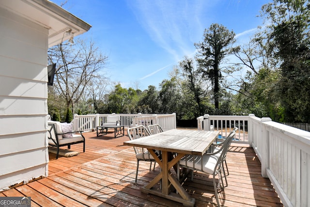 570 Southview Dr, Athens, GA 30605 - deck featuring outdoor dining space and view of wooded area