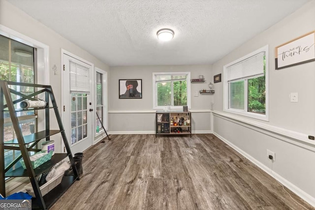 135 Dunwick Ln, Mcdonough, GA 30253 - unfurnished room with wood finished floors, a textured ceiling, and baseboards
