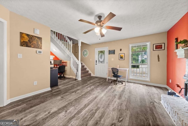 135 Dunwick Ln, Mcdonough, GA 30253 - living area with wood finished floors, stairs, a ceiling fan, a desk, and a textured ceiling