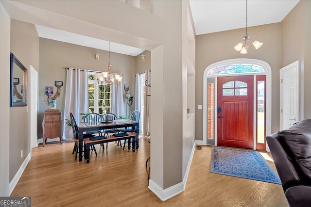 11 Crossbridge Ct, Cartersville, GA 30120 - entrance foyer featuring a chandelier, high vaulted ceiling, baseboards, and light wood finished floors