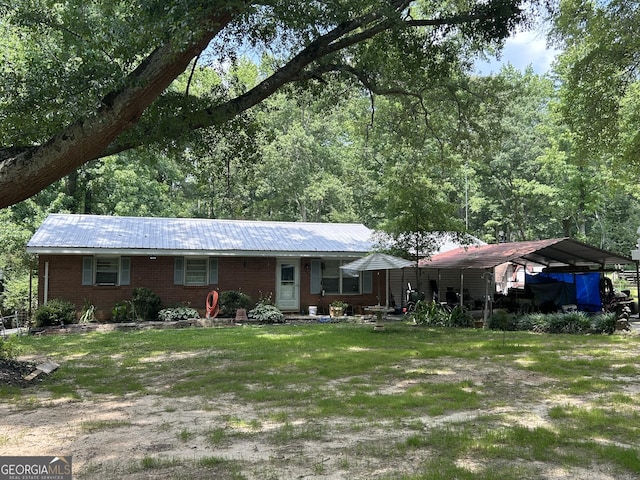 3683 Miller St, Lithia Springs, GA 30122 - view of front of home featuring a detached carport, a metal roof, and a front lawn