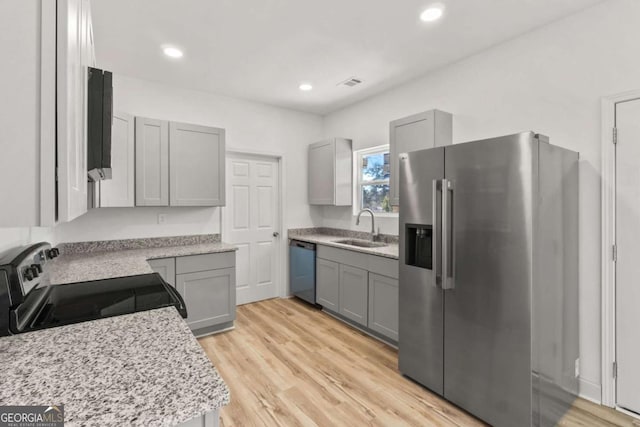 30 Moore Ave, Toccoa, GA 30577 - kitchen featuring appliances with stainless steel finishes, gray cabinets, light wood-style flooring, and recessed lighting