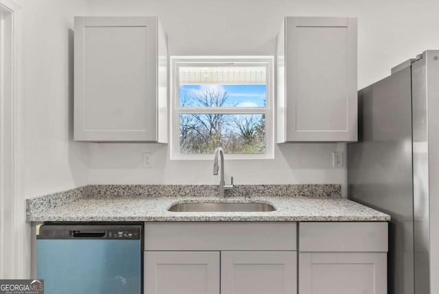 30 Moore Ave, Toccoa, GA 30577 - kitchen featuring dishwasher, freestanding refrigerator, and light stone countertops