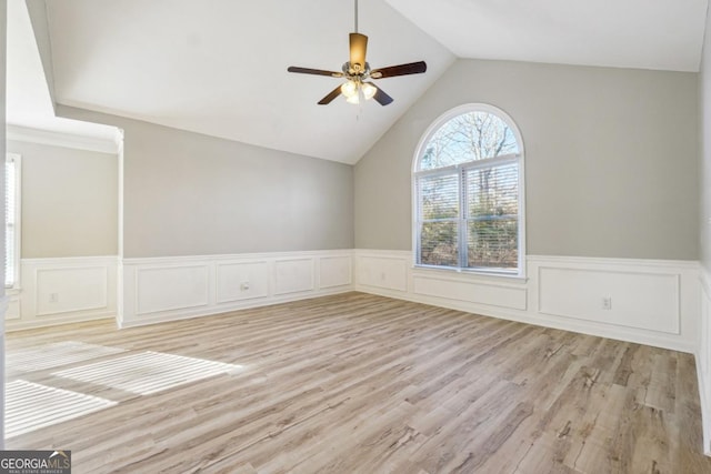 20 Trace Ct, Covington, GA 30016 - unfurnished room featuring wainscoting, ceiling fan, vaulted ceiling, light wood-style flooring, and a decorative wall