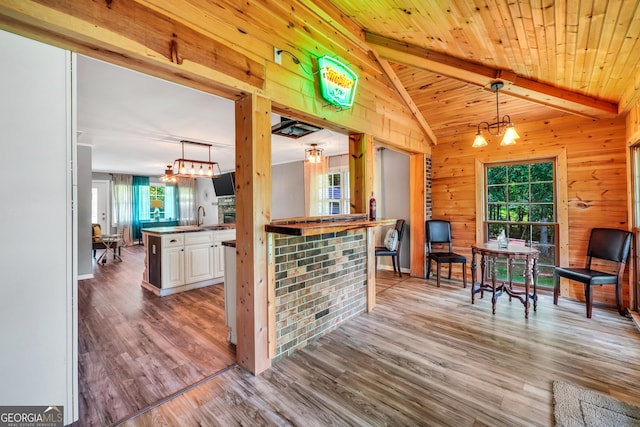 113 Fletcher Rd, Eatonton, GA 31024 - kitchen featuring healthy amount of natural light, wood finished floors, wood walls, and white cabinetry
