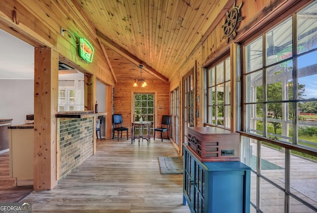 113 Fletcher Rd, Eatonton, GA 31024 - hallway featuring lofted ceiling, wood finished floors, wood walls, and wooden ceiling