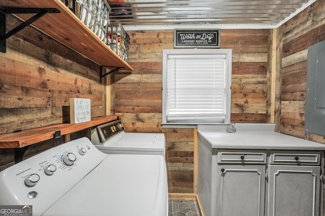 113 Fletcher Rd, Eatonton, GA 31024 - washroom with washer and dryer, wood walls, and cabinet space