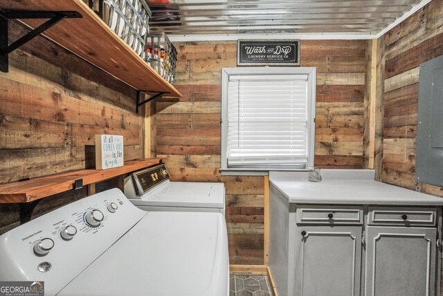 113 Fletcher Rd, Eatonton, GA 31024 - laundry room featuring washer and clothes dryer, wood walls, and cabinet space