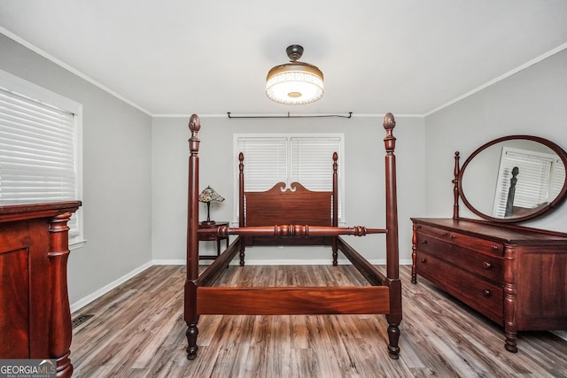 113 Fletcher Rd, Eatonton, GA 31024 - bedroom featuring wood finished floors, baseboards, and crown molding