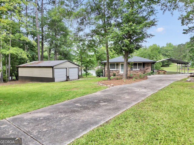 113 Fletcher Rd, Eatonton, GA 31024 - view of front facade featuring an outbuilding, a garage, a front lawn, and a detached carport