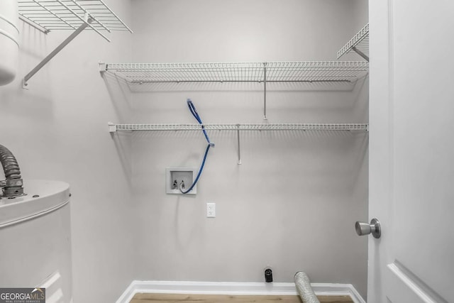 1045 Barley Dr, Hinesville, GA 31313 - washroom with baseboards, electric dryer hookup, wood finished floors, water heater, and washer hookup