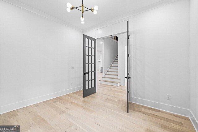1387 Mineral Springs Rd, Hoschton, GA 30548 - unfurnished room featuring french doors, stairway, a chandelier, light wood-style floors, and baseboards