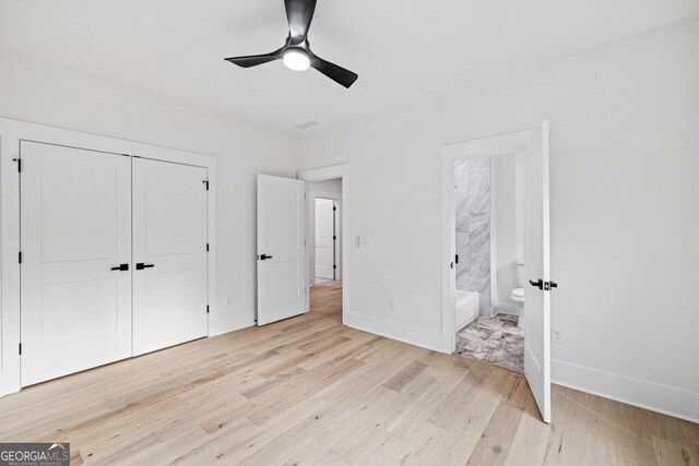 1387 Mineral Springs Rd, Hoschton, GA 30548 - unfurnished bedroom featuring light wood-style floors, baseboards, a closet, connected bathroom, and a ceiling fan