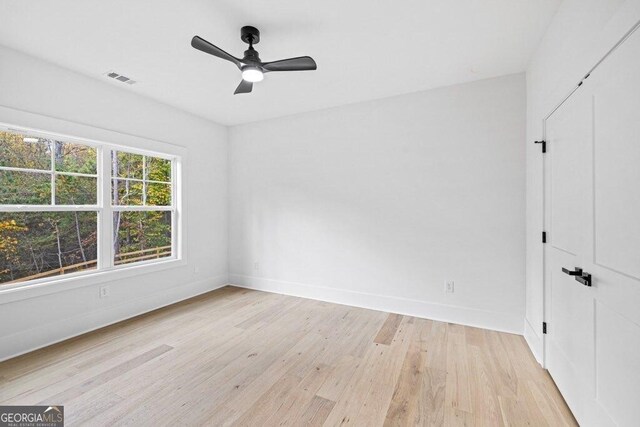 1387 Mineral Springs Rd, Hoschton, GA 30548 - empty room with baseboards, light wood-style floors, and a ceiling fan