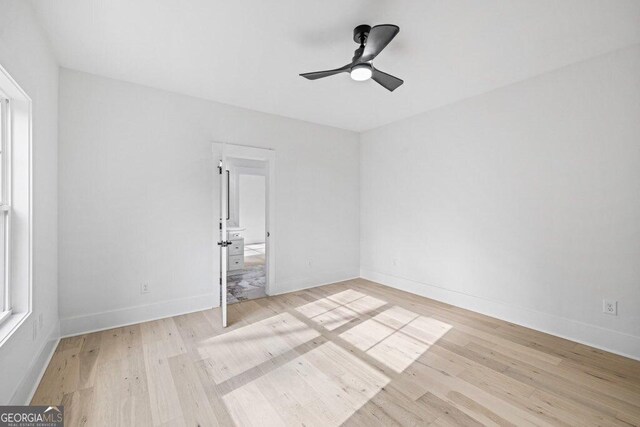 1387 Mineral Springs Rd, Hoschton, GA 30548 - empty room with light wood-style floors, a ceiling fan, and baseboards