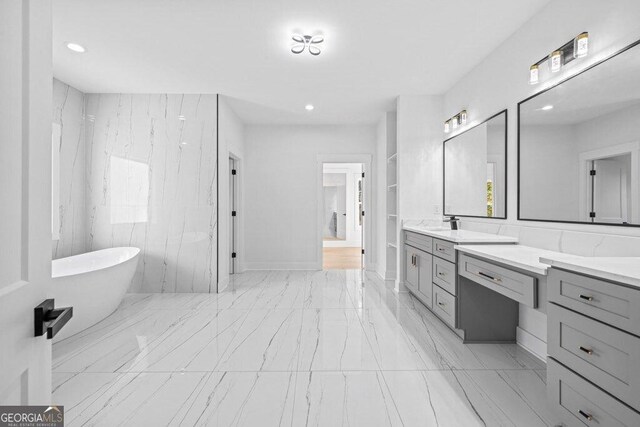 1387 Mineral Springs Rd, Hoschton, GA 30548 - bathroom with marble finish floors, a freestanding bath, vanity, recessed lighting, and baseboards