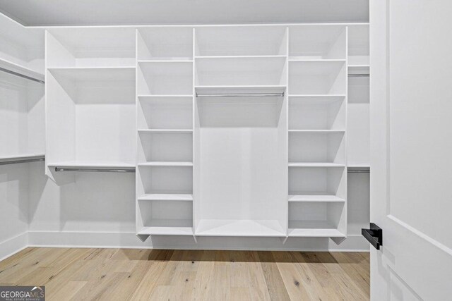 1387 Mineral Springs Rd, Hoschton, GA 30548 - walk in closet featuring wood finished floors