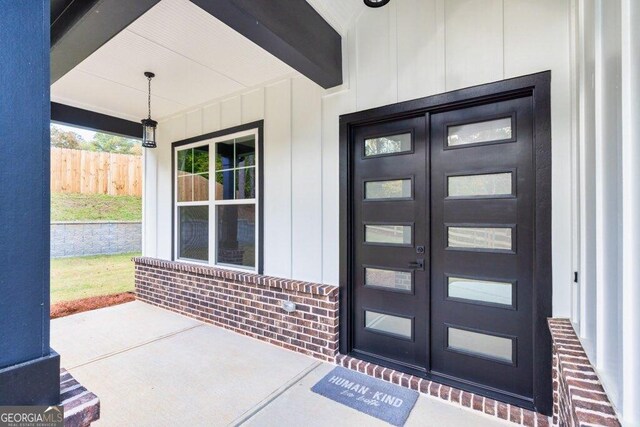 1387 Mineral Springs Rd, Hoschton, GA 30548 - doorway to property featuring french doors, board and batten siding, and brick siding