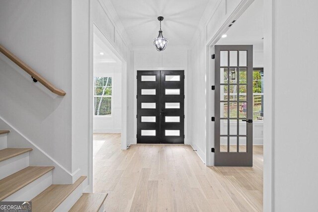 1387 Mineral Springs Rd, Hoschton, GA 30548 - foyer entrance with stairway, french doors, wood finished floors, and baseboards