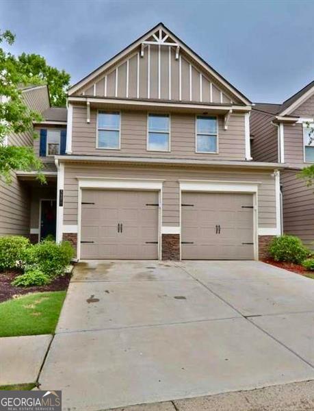 3277 Castleberry Vlg, Cumming, GA 30040 - craftsman-style house with board and batten siding, an attached garage, driveway, and stone siding