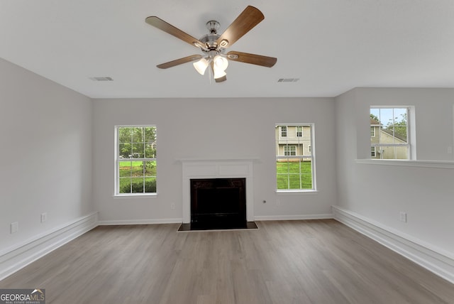 907 Brisley Cir, Hampton, GA 30228 - unfurnished living room with wood finished floors, a ceiling fan, and a fireplace