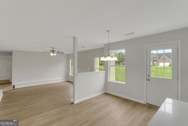 907 Brisley Cir, Hampton, GA 30228 - foyer entrance with light wood finished floors, ceiling fan, and a chandelier