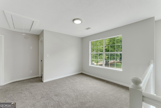 907 Brisley Cir, Hampton, GA 30228 - carpeted empty room featuring attic access and baseboards