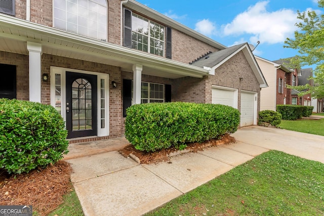 907 Brisley Cir, Hampton, GA 30228 - view of front of property with brick siding, covered porch, a garage, and concrete driveway