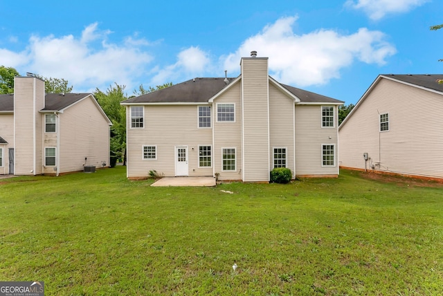 907 Brisley Cir, Hampton, GA 30228 - rear view of house featuring a patio, a lawn, and a chimney