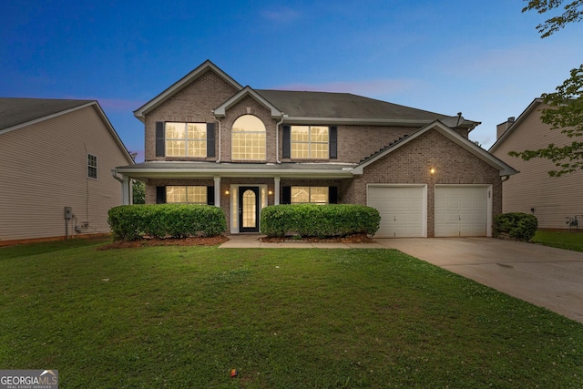 907 Brisley Cir, Hampton, GA 30228 - traditional-style house with brick siding, driveway, a garage, a front yard, and covered porch