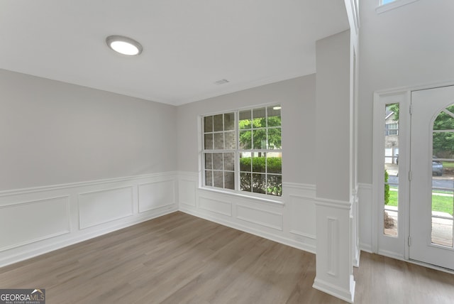 907 Brisley Cir, Hampton, GA 30228 - spare room with plenty of natural light, a wainscoted wall, light wood-style floors, and a decorative wall