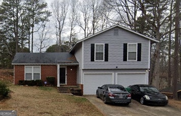 3823 Rock Hollow Ct, Conley, GA 30288 - tri-level home with a garage and concrete driveway
