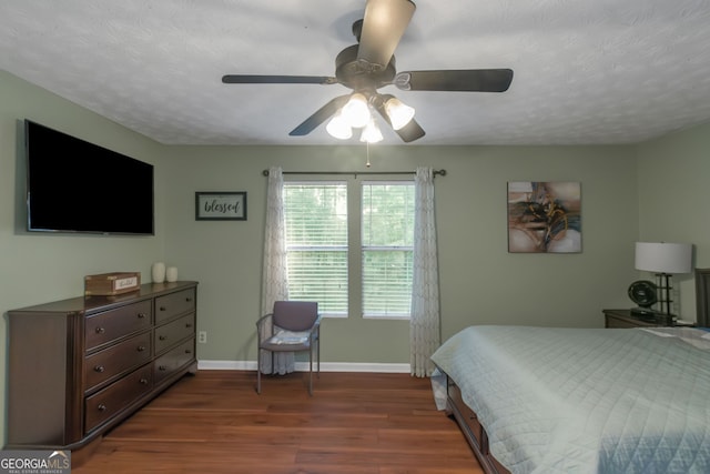 3823 Rock Hollow Ct, Conley, GA 30288 - bedroom with dark wood-type flooring, a textured ceiling, and a ceiling fan