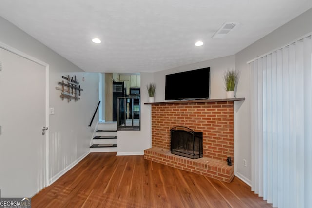 3823 Rock Hollow Ct, Conley, GA 30288 - unfurnished living room featuring wood finished floors, recessed lighting, a fireplace, and stairway