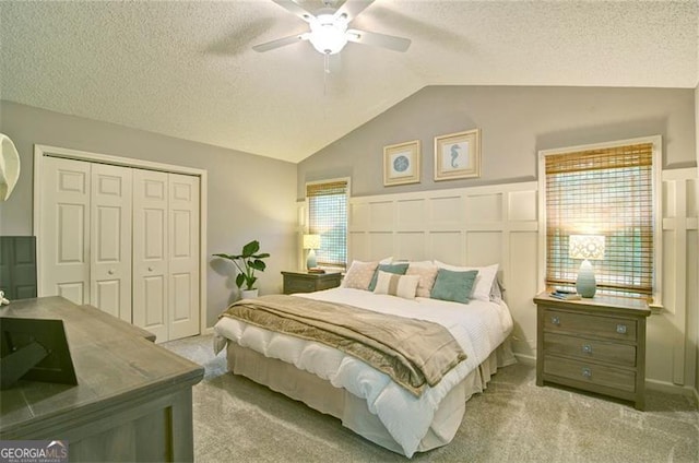 368 Lambeth Dr, Hiram, GA 30141 - carpeted bedroom featuring vaulted ceiling, a closet, a textured ceiling, ceiling fan, and a wainscoted wall