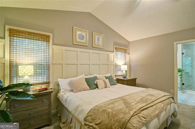 368 Lambeth Dr, Hiram, GA 30141 - bedroom with vaulted ceiling, carpet floors, and connected bathroom