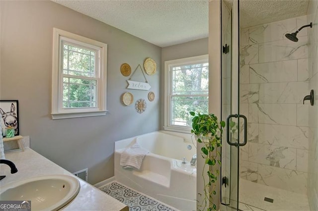 368 Lambeth Dr, Hiram, GA 30141 - full bathroom featuring a garden tub, a textured ceiling, a shower stall, double vanity, and baseboards