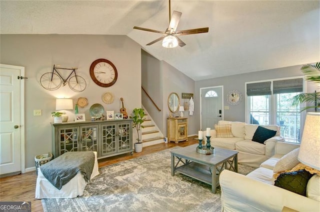 368 Lambeth Dr, Hiram, GA 30141 - living area featuring stairway, vaulted ceiling, wood finished floors, ceiling fan, and baseboards