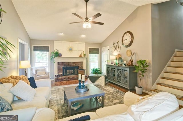 368 Lambeth Dr, Hiram, GA 30141 - living area featuring lofted ceiling, a ceiling fan, stairway, wood finished floors, and a fireplace