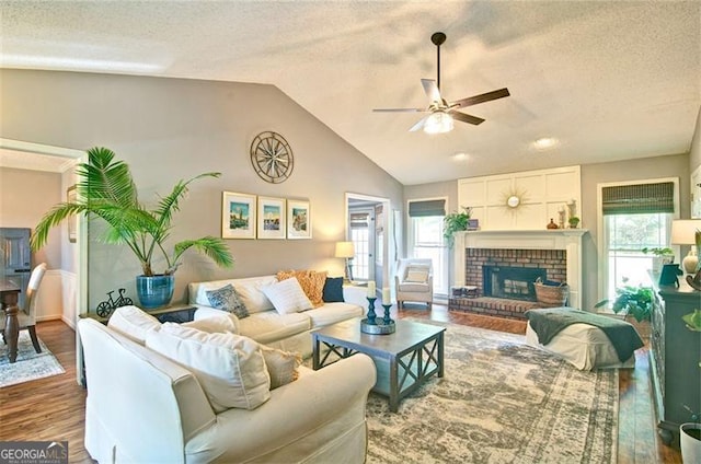 368 Lambeth Dr, Hiram, GA 30141 - living area with wood finished floors, ceiling fan, a textured ceiling, lofted ceiling, and a fireplace