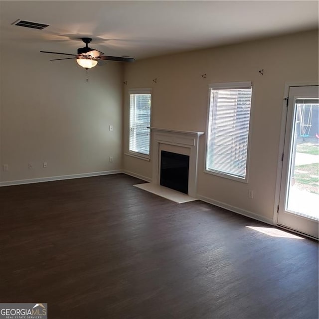 1030 Glenwyck Dr, Braselton, GA 30517 - unfurnished living room with dark wood-style flooring, healthy amount of natural light, and baseboards
