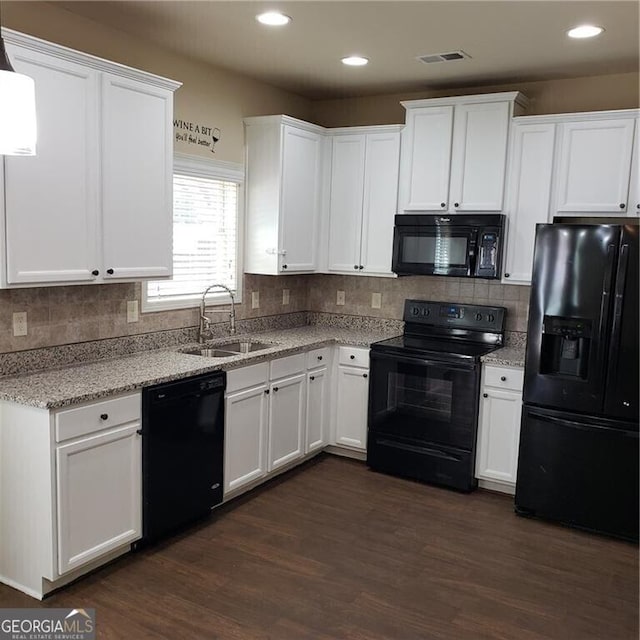 1030 Glenwyck Dr, Braselton, GA 30517 - kitchen featuring black appliances, a sink, white cabinets, dark wood-style floors, and recessed lighting